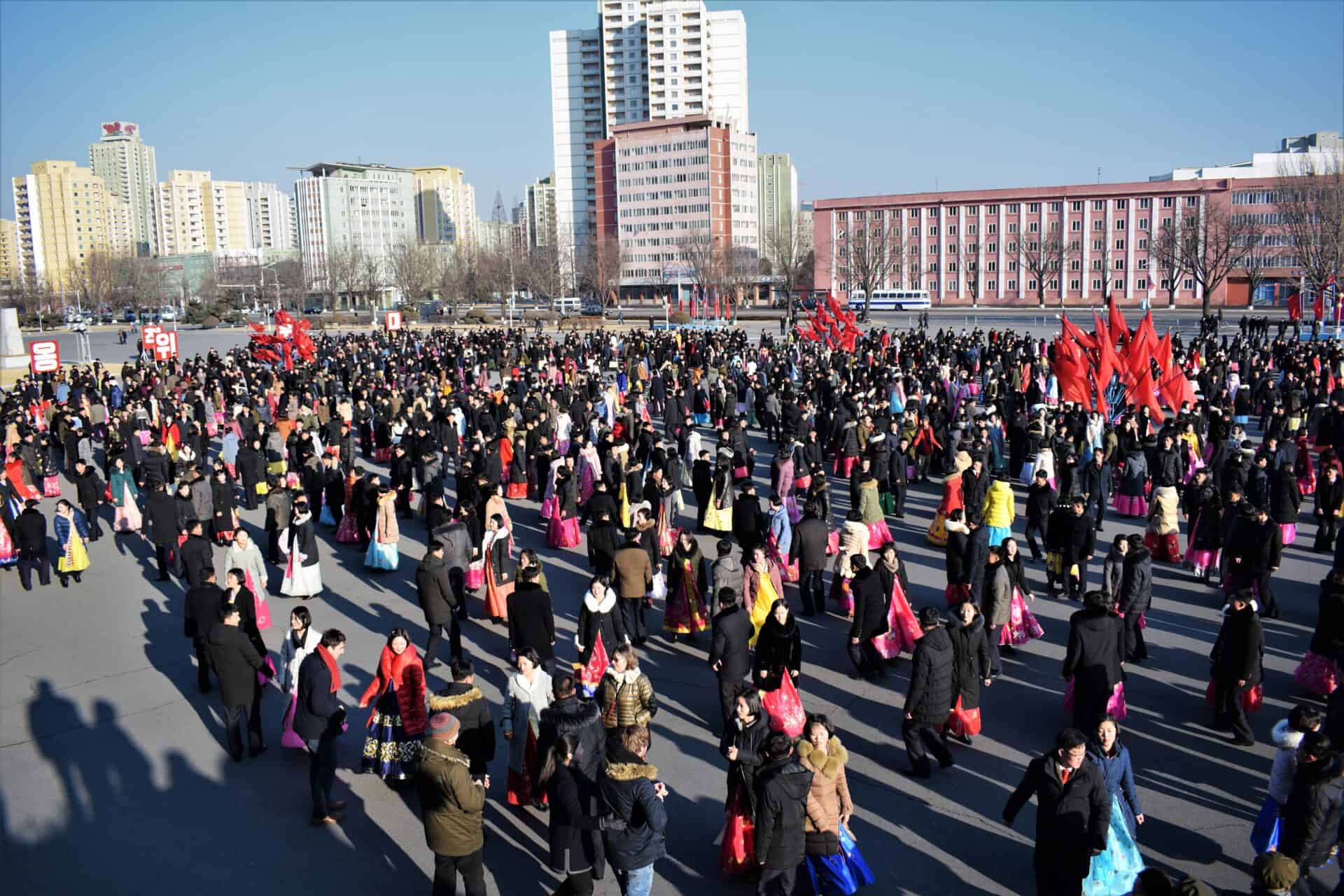 hundreds of North Korean students dance together in celebration of their former leader Kim Jong-il