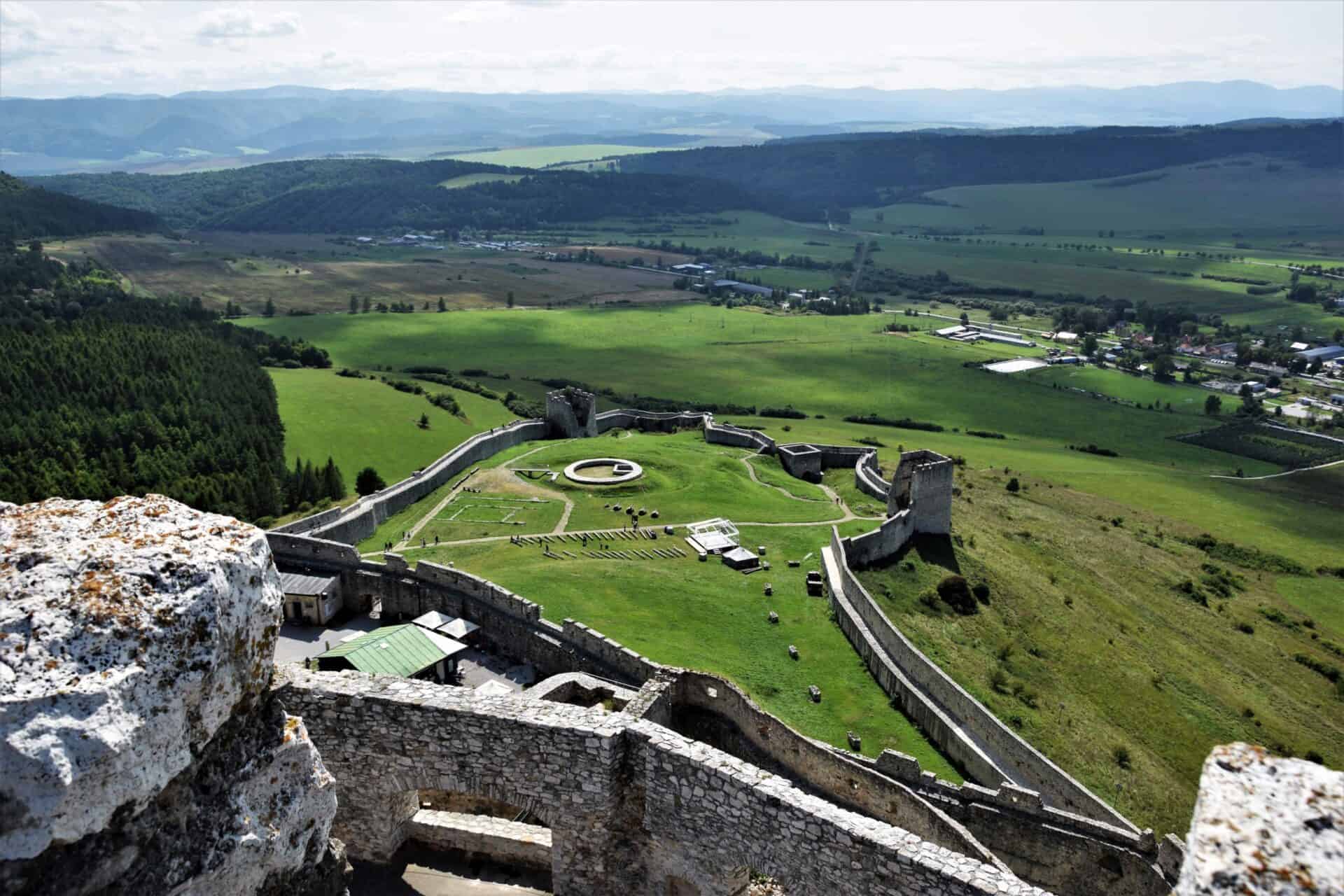 view of the lower bailey of Spiš Castle and the surrounding fields and hills; seen from the top of the castle keep, Slovakia