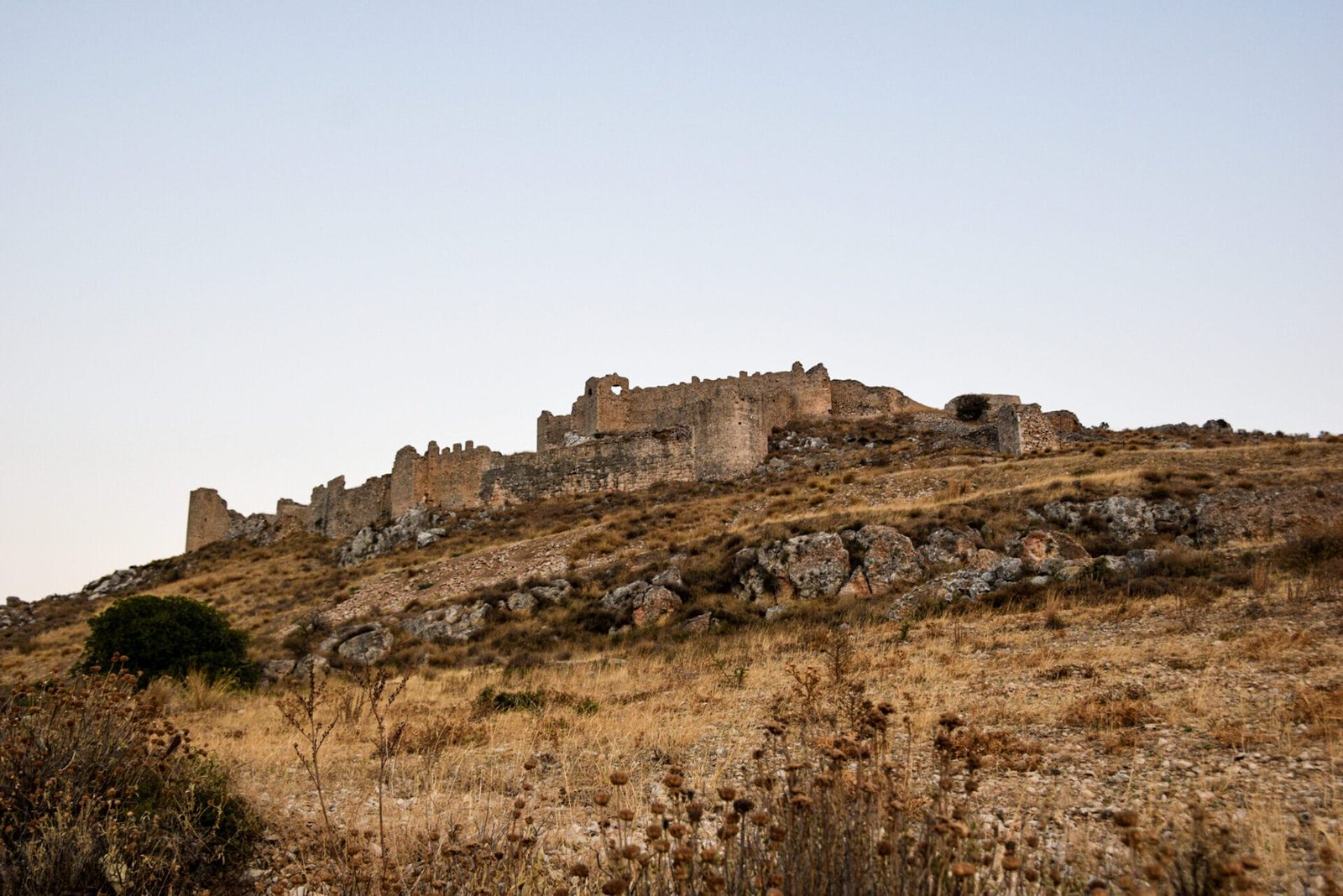 towering remains of a Frankish Crusader castle on top of a hill
