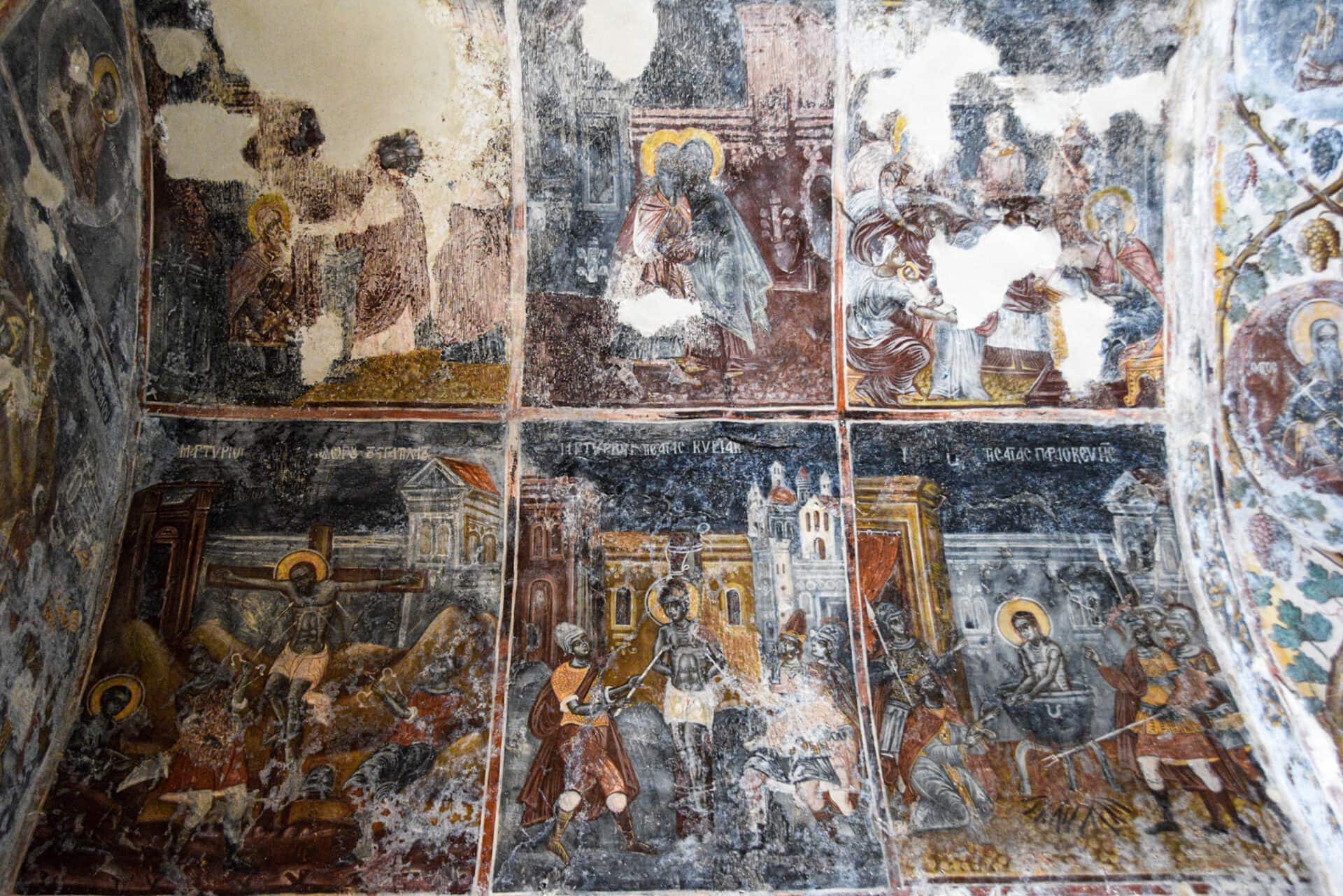 a series of colourful and graphic wall paintings depicting the brutal torture of Christian martyrs