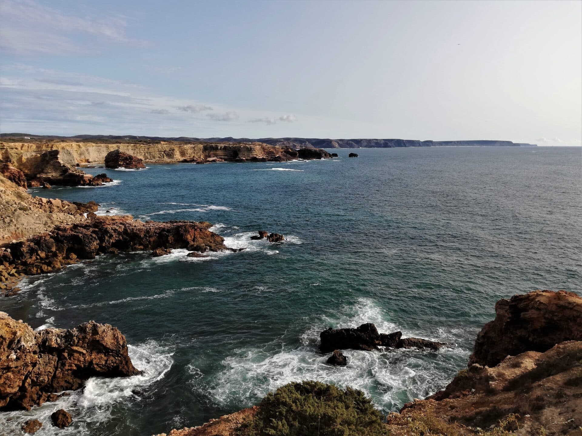 waves crush against rugged cliffs, forming a dramatic coastline