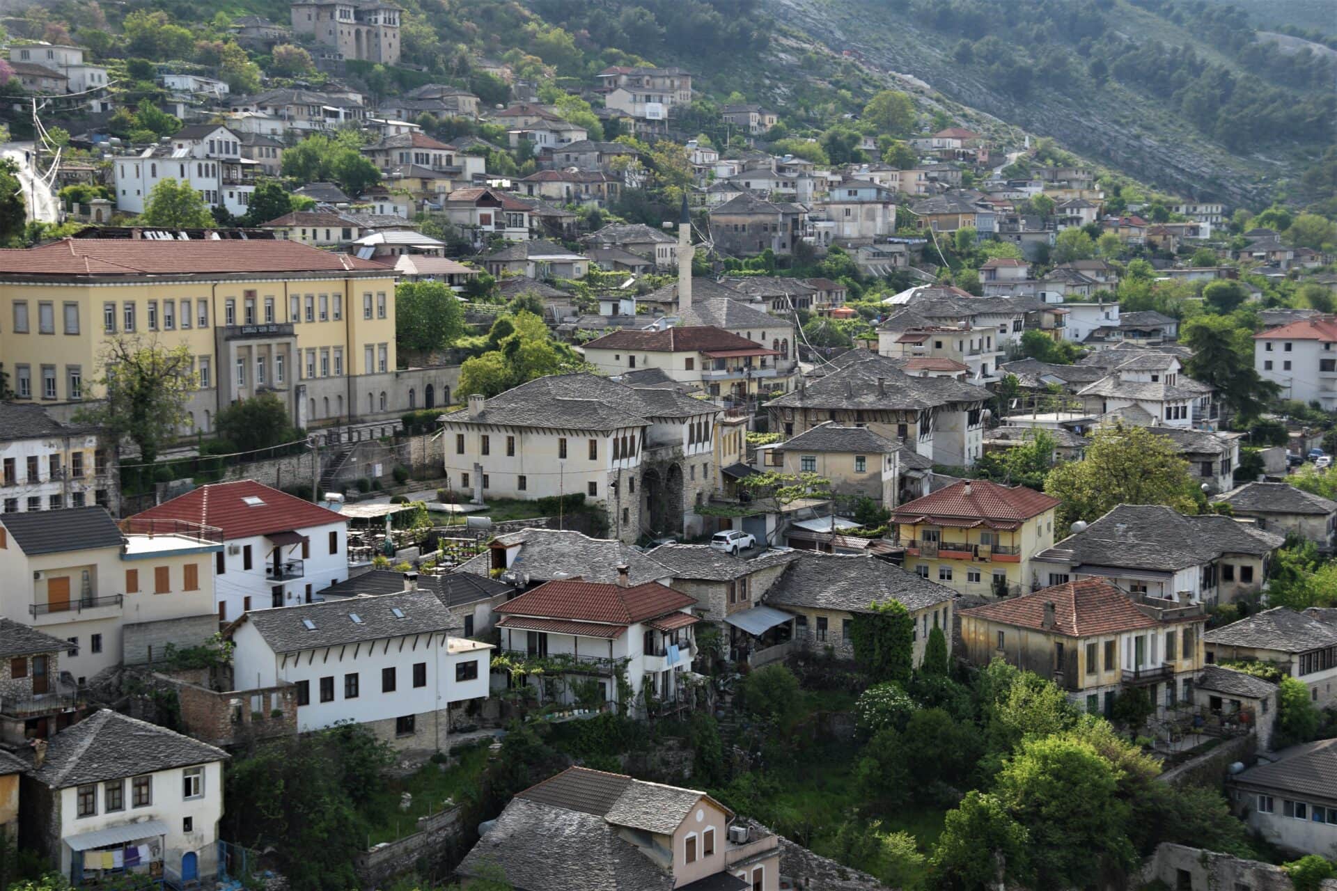 houses crawling up a hillside in the city of Gjirokaster