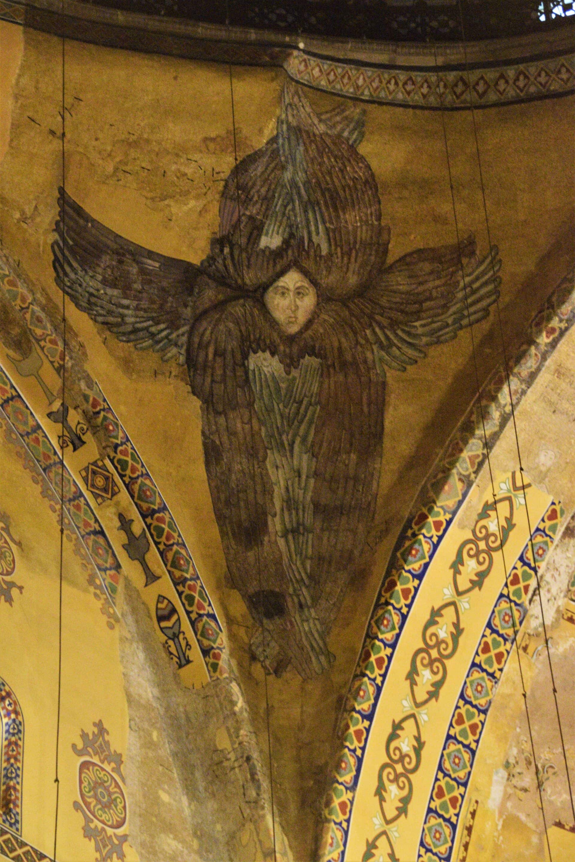 giant mural of an angel on one of the spandrels holding the main dome of the Hagia Sophia