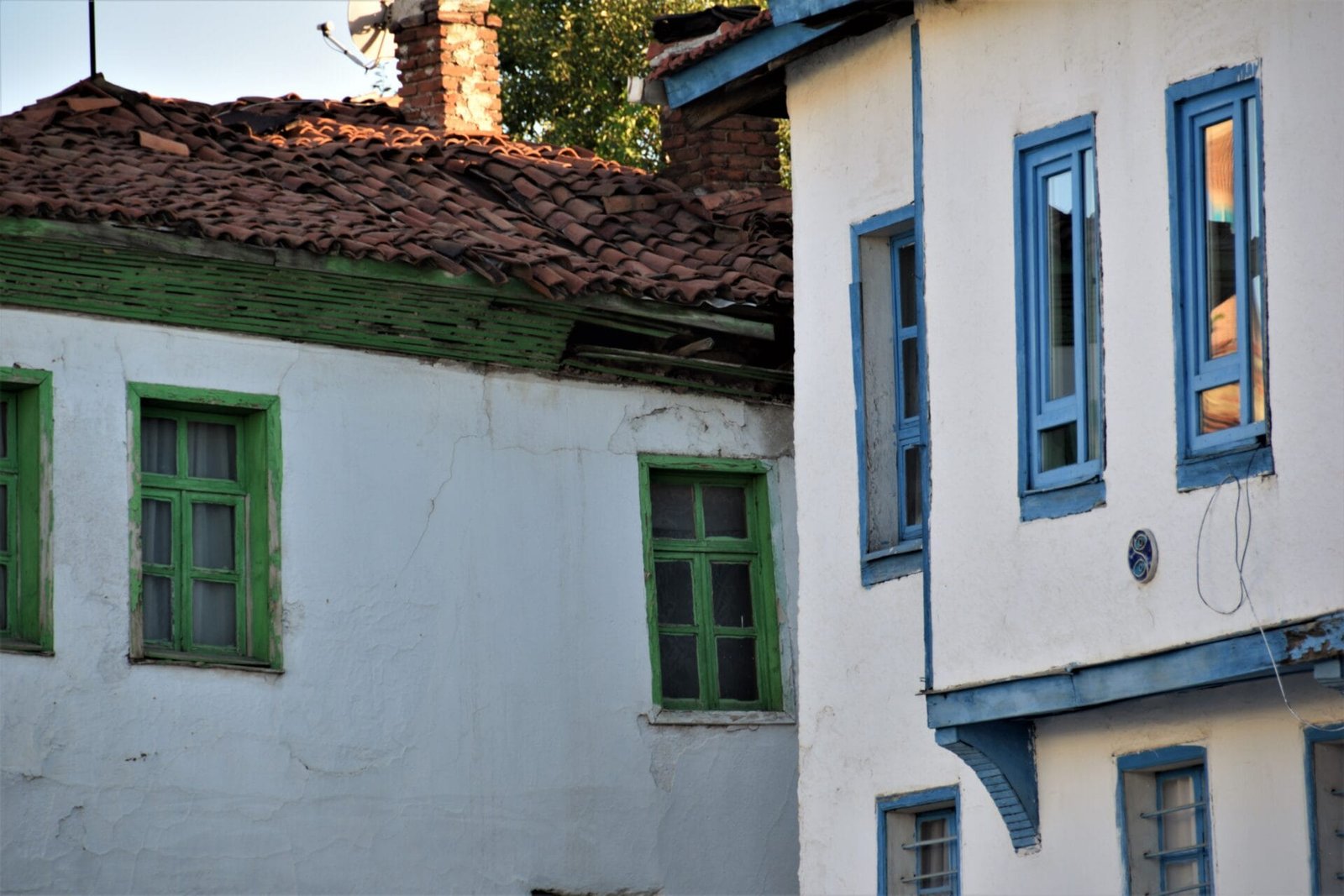 whitewashed Ottoman houses with blue and green framed windows