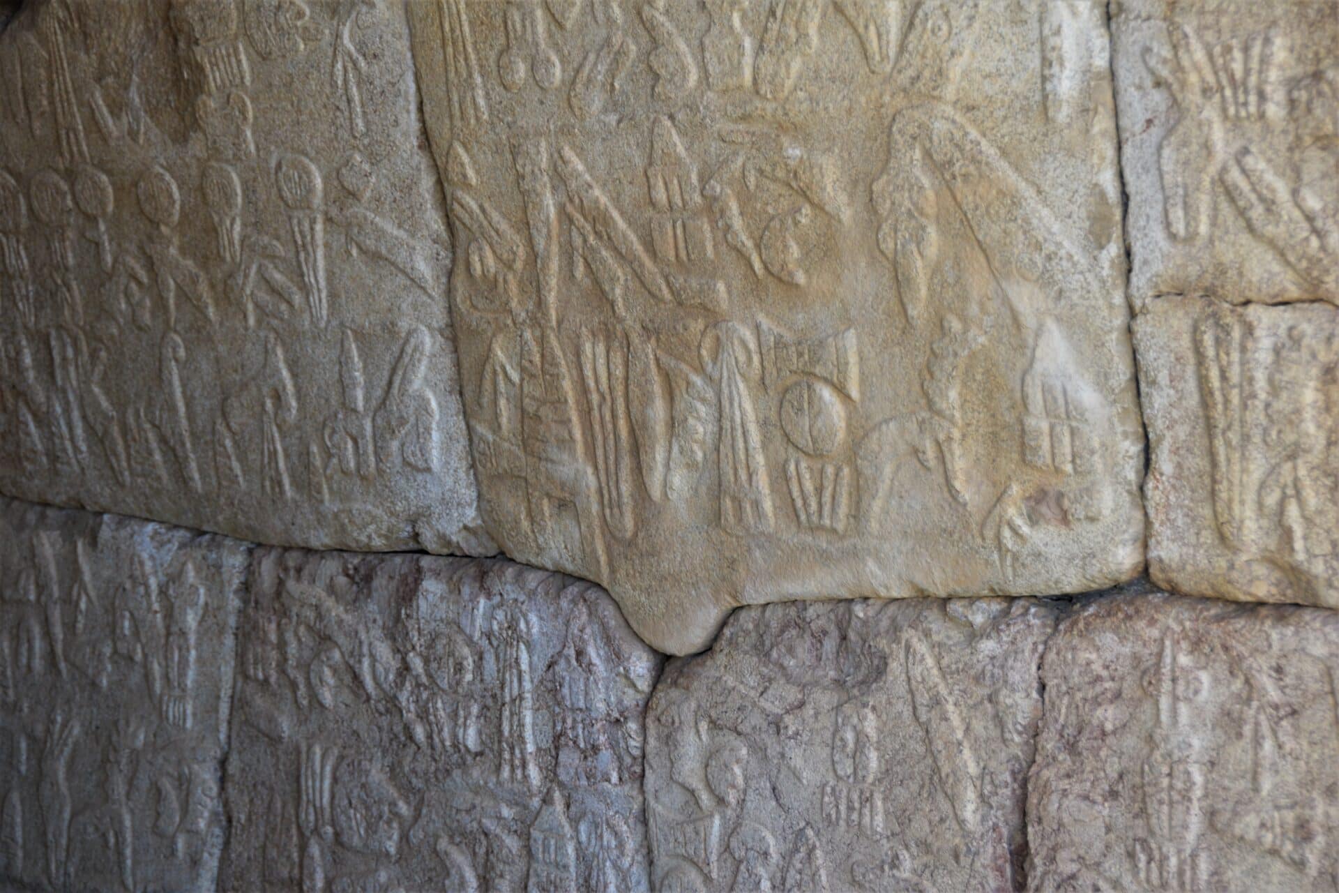 hieroglyphs on a monolithic stone wall