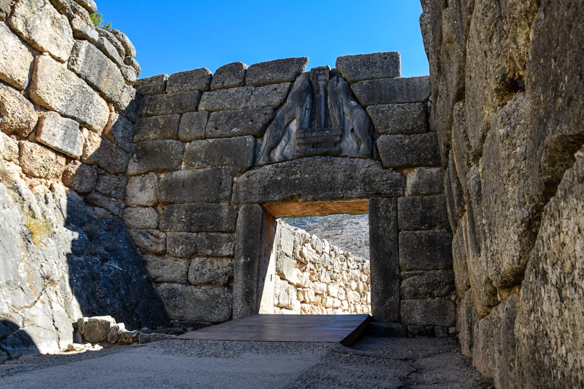 ruined site of Mycenae featuring two lions leaning on an altar carved into a single stone above the entrance