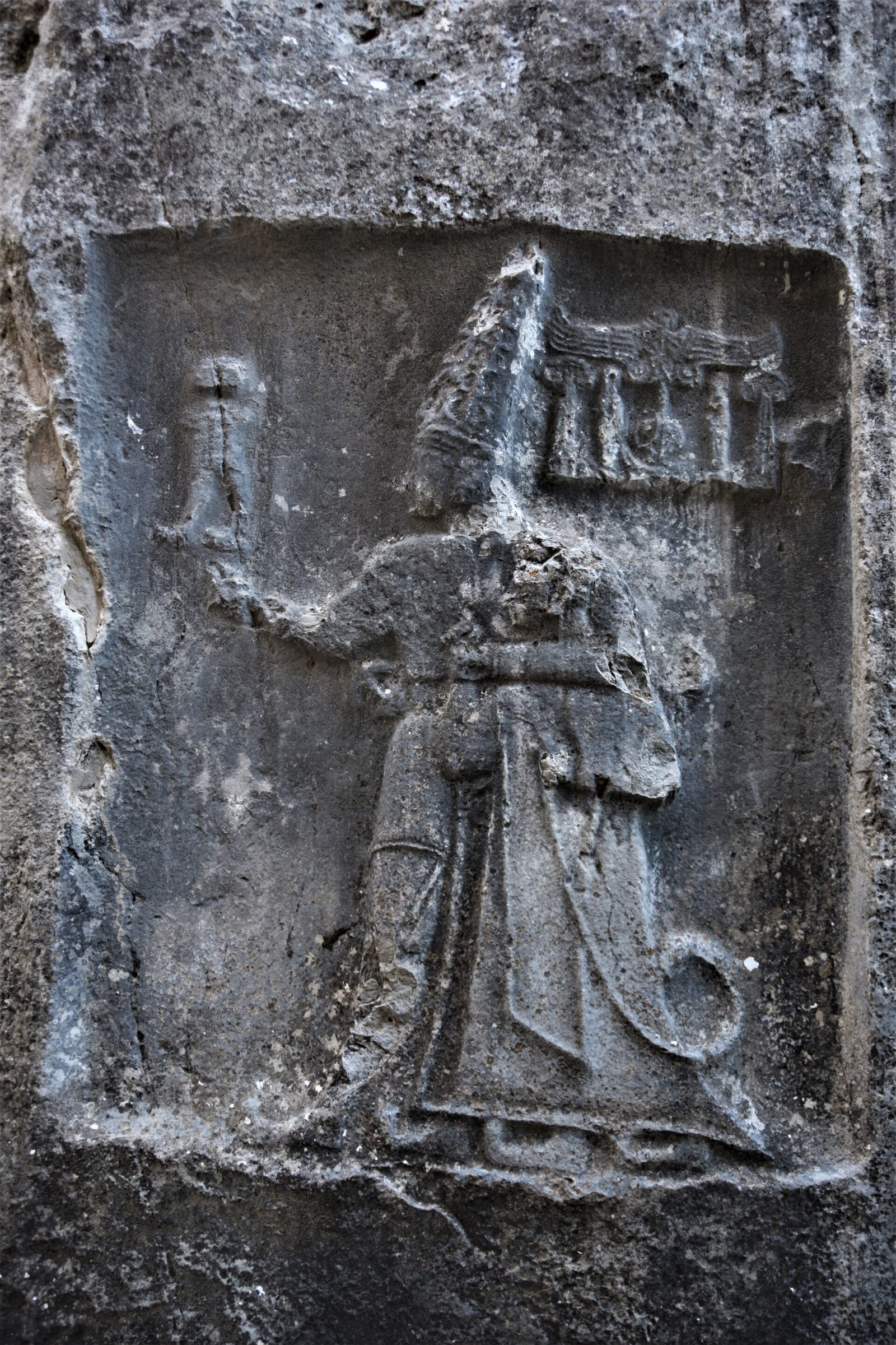 Hittite stone carving showing a king walking next to a god