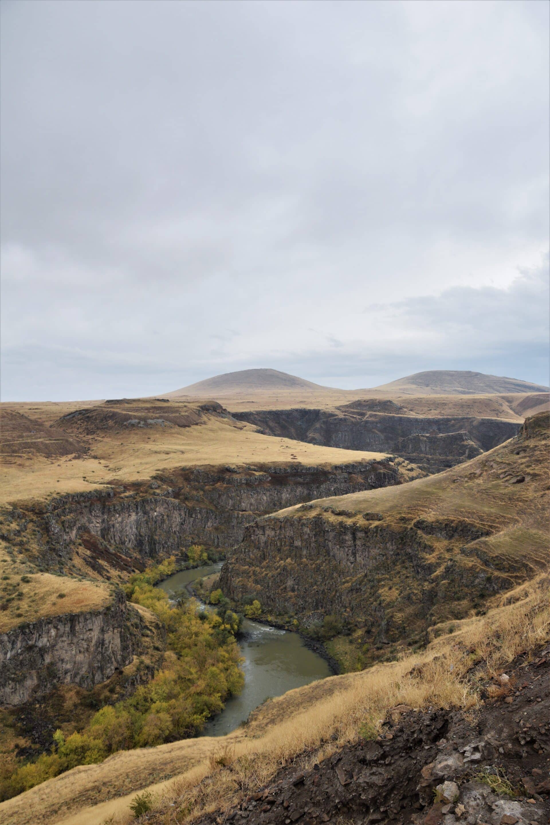 a canyon cuts through a barren plain separating Turkey and Armenia