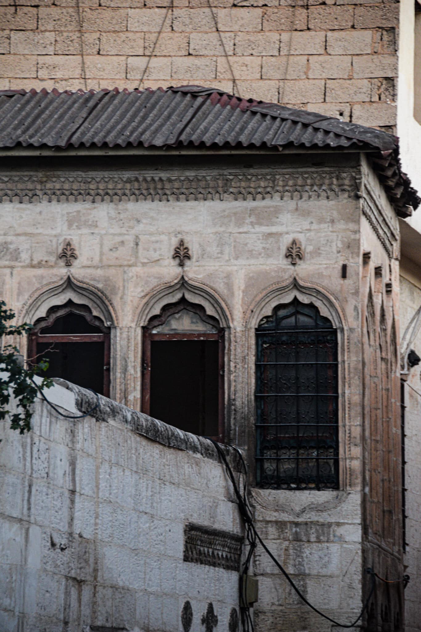 three barred windows, framed by beautiful Oriental carvings in Sanliurfa's old town