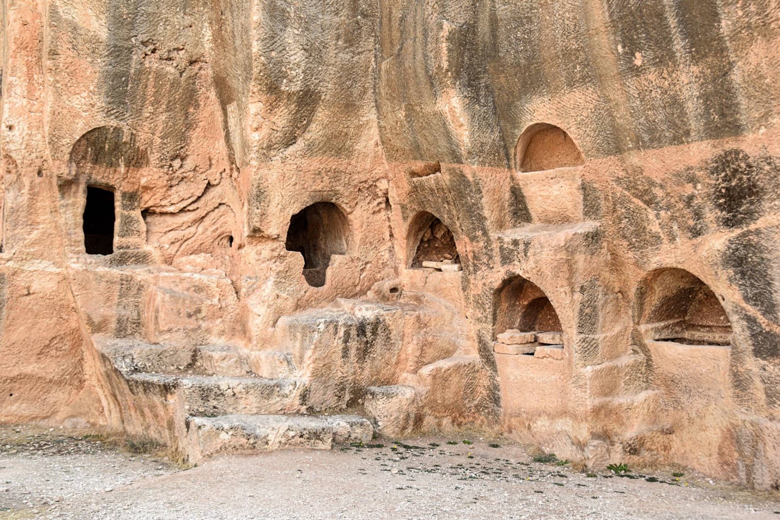 Roman tombs cut into the smooth rockface of an old quarry in the ancient city of Dara
