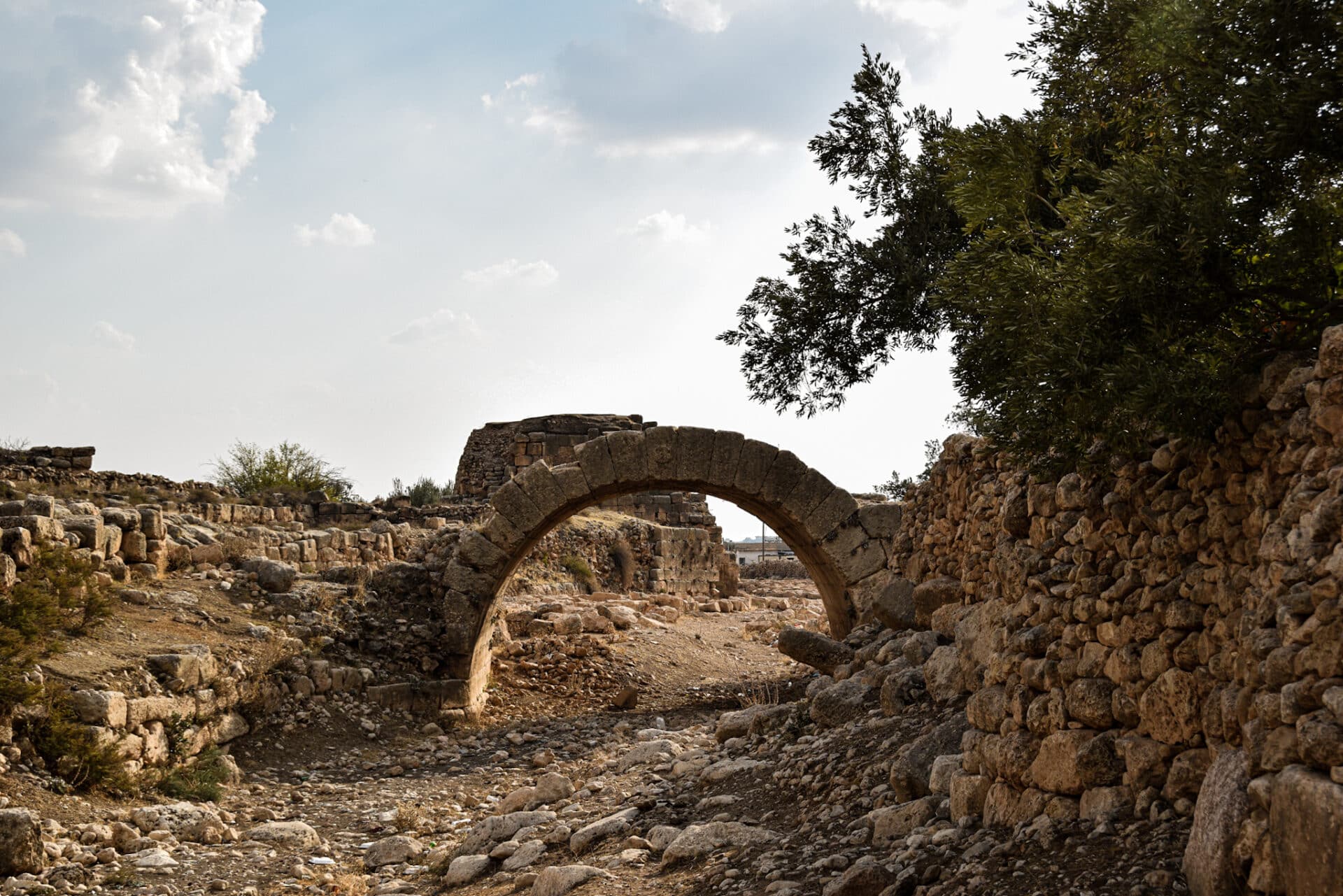 an old Roman bridge spans a dried up riverbed in the ancient city of Dara