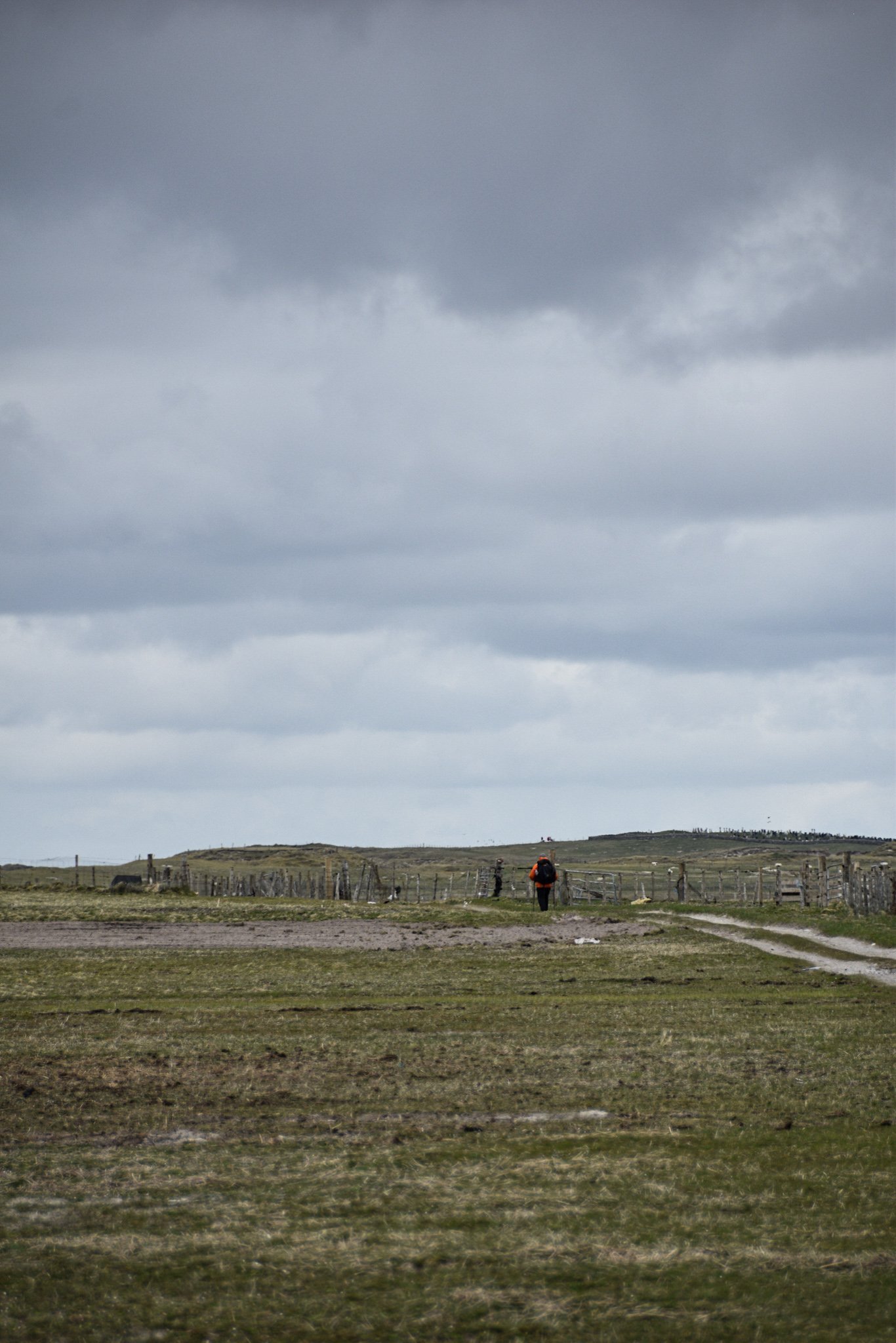 a female hiker walks across a field on South Uist