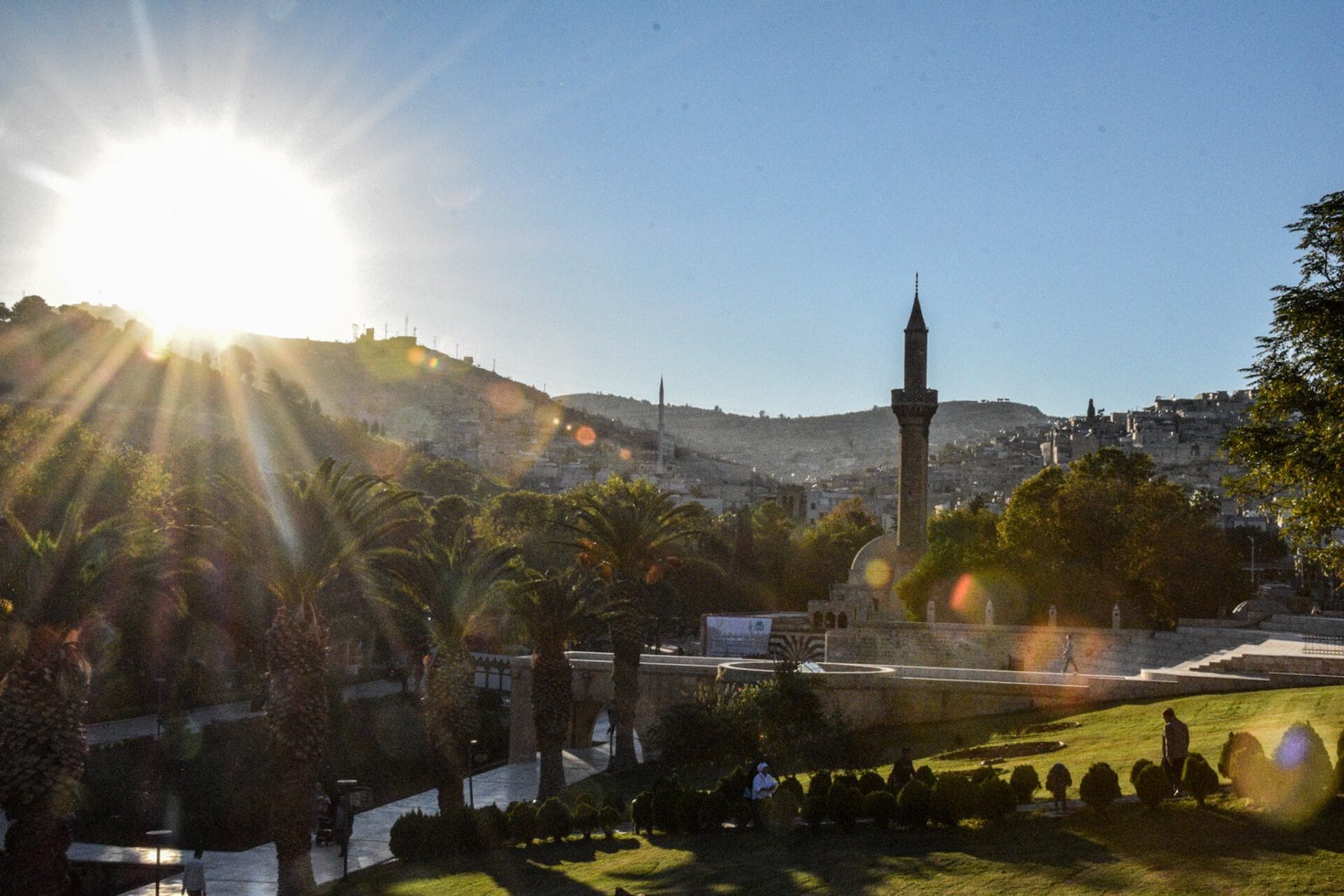 the sun stands blazing above the verdant parks of Sanliurfa