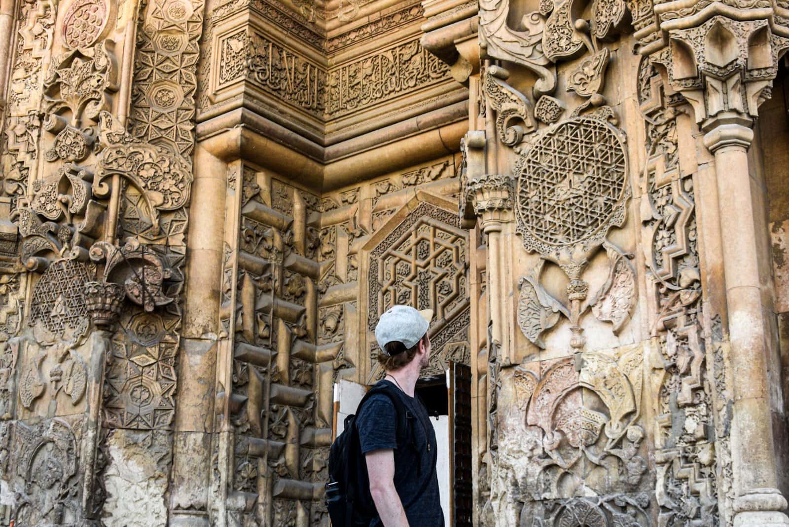 the author standing in front of the magnificent gate of the Mosque in Divrigi