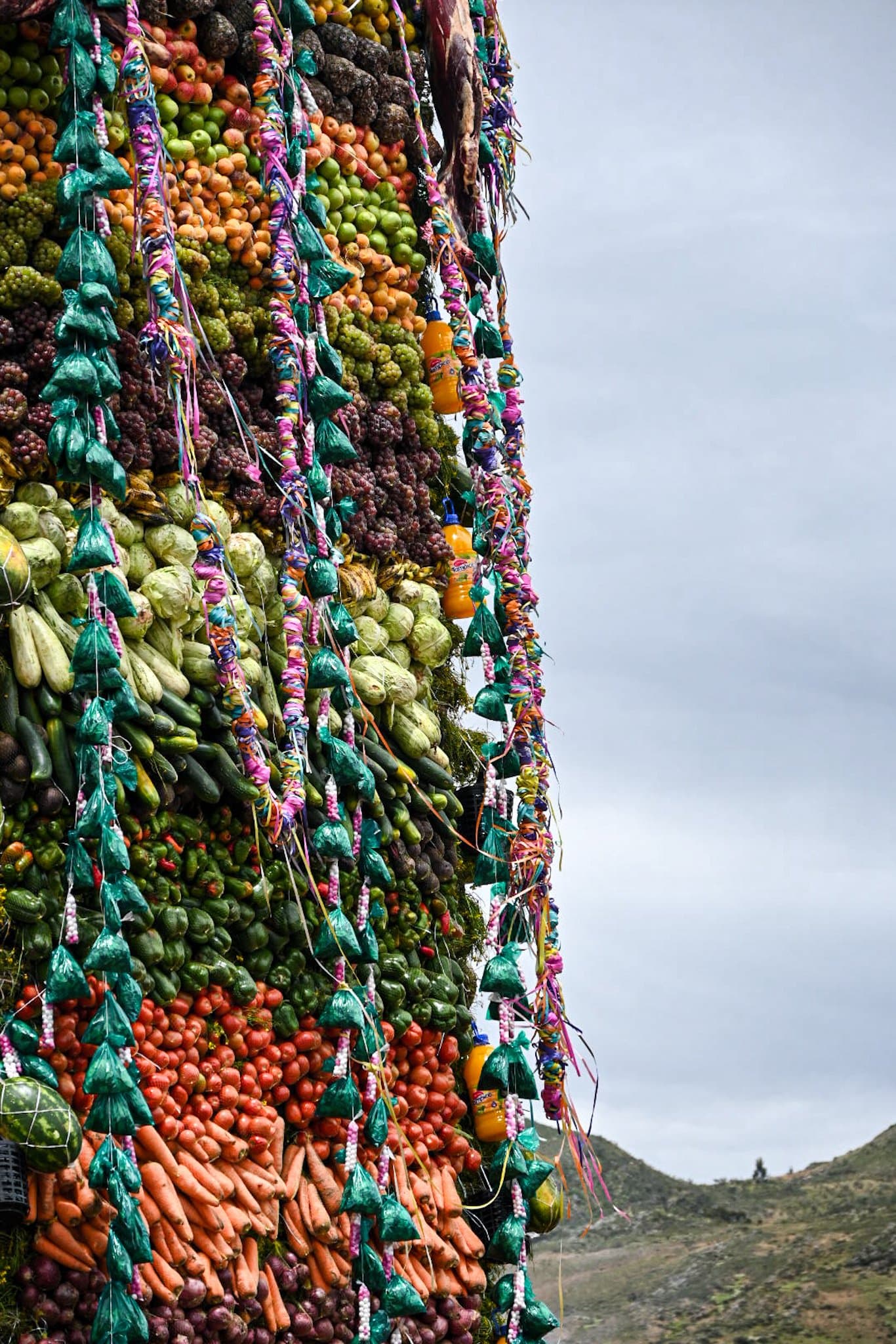 various products, such as vegetables, fruits, canned food, and chicha adorn the Gran Pukara altar in Tarabuco