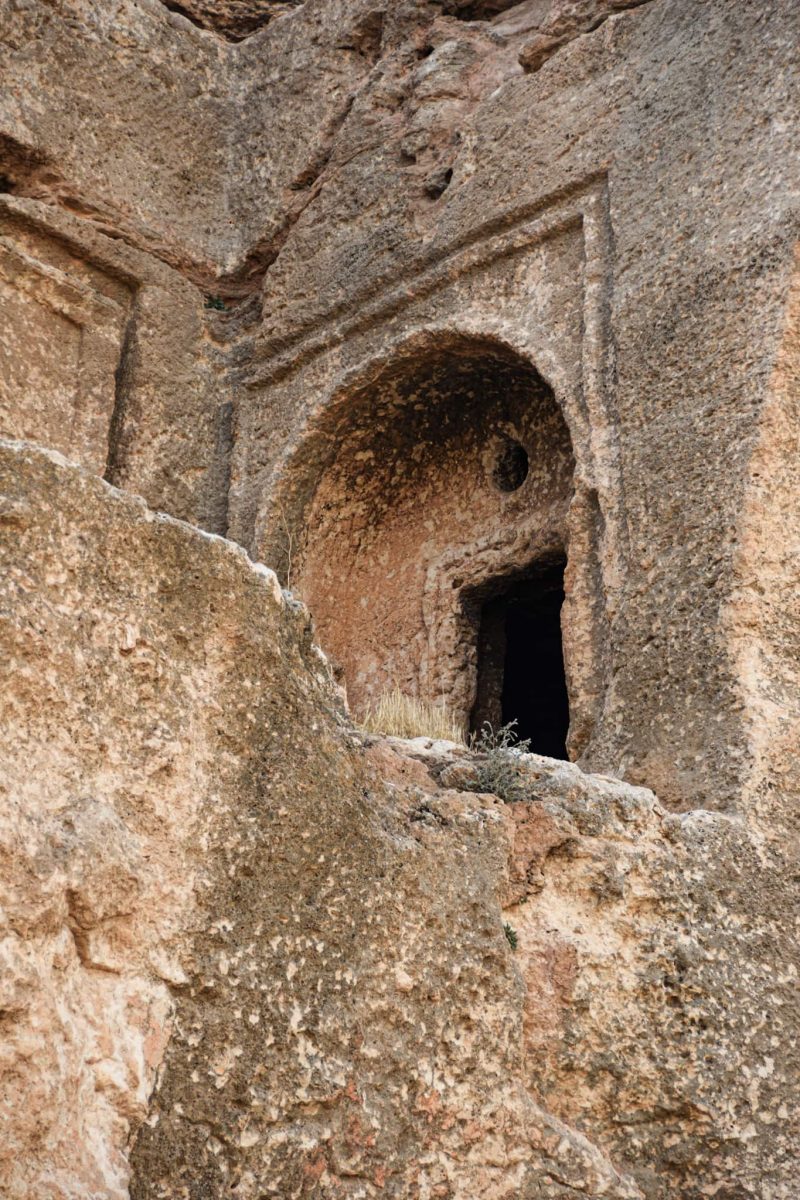 small entrance to a tomb carved into the rock in the ancient city of Dara